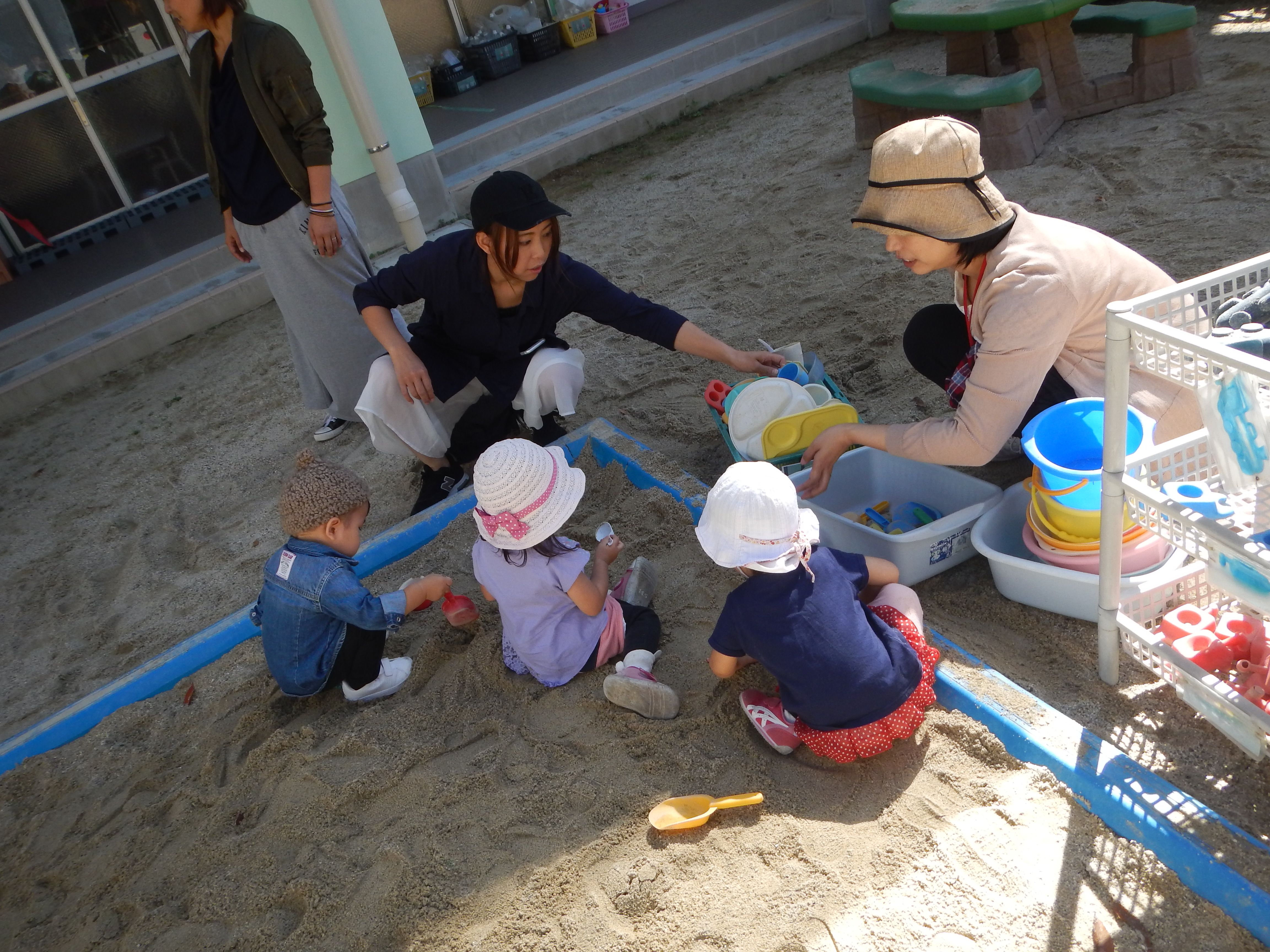 砂場で親子で遊んでいる