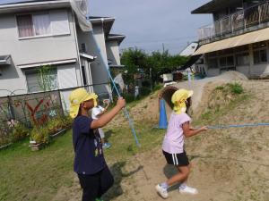 5歳児　遊びの様子　園庭で虫捕り遊び