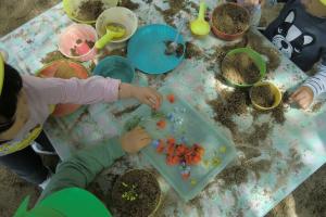 1歳児がお花で砂遊びをしている