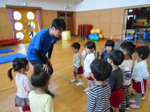 3歳児が体操の先生の話を聞いています