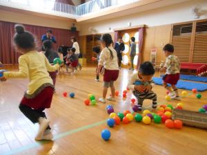 3歳児がカラーボールを拾っています