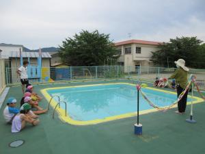プールサイドで園長先生の話