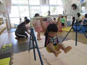 鉄棒に挑戦する子ども