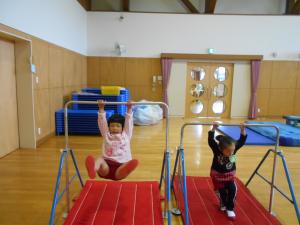 鉄棒にぶら下がる子ども達