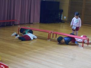 椅子の下をくぐる子ども