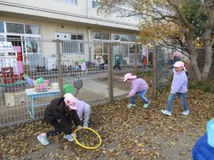 5歳児園庭で落ち葉で遊ぶ様子
