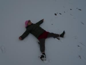 5歳児が雪の上で寝転がっています