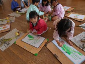 5歳児タマネギの色塗りをしています