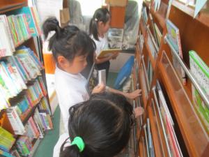 移動図書の中で絵本を選んでいる子ども達