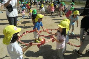 息を合わせてフープでダンスをする子ども