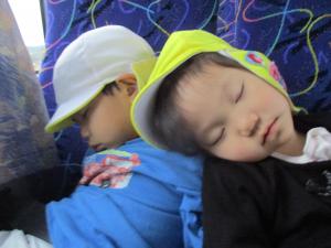 バスでぐっすり寝る子供