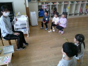 3歳児が保育者の話を聞いています