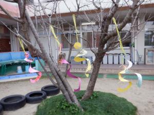 桜の木につるした凧がユラユラ揺れている様子。