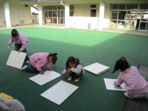 画板を雑巾で拭いている園児