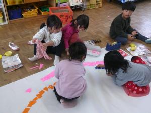 お別れ会の看板の虹をつくっている子ども達