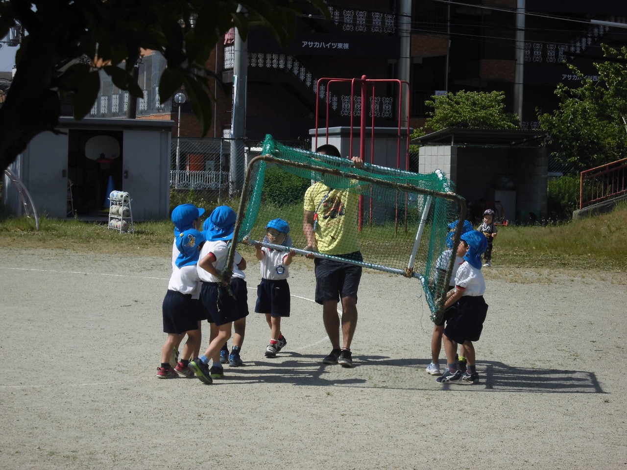 サッカーゴールを準備する5歳児と担任